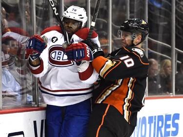 P.K.  Subban (76) of the Montreal Canadiens takes a check from Corey Perry (10) of the Anaheim Ducks during the first period at Honda Center on March 4, 2015 in Anaheim, California.