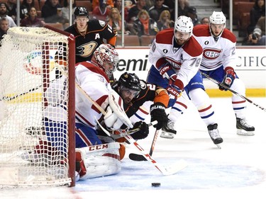 Carey Price (31) of the Montreal Canadiens makes a save on Kyle Palmieri (21) of the Anaheim Ducks as Andrei Markov (79) and Alex Galchenyuk (27) look for  a rebound along with Corey Perry (10) during the first period at Honda Center on March 4, 2015 in Anaheim, California.