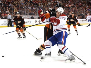 Dale Weise (22) of the Montreal Canadiens fends off Josh Manson (42) of the Anaheim Ducks as he drives to the net during the second period at Honda Center on March 4, 2015 in Anaheim, California.