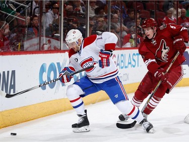 Torrey Mitchell #17 of the Montreal Canadiens skates with the puck under pressure from Connor Murphy #5 of the Arizona Coyotes during the second period of the NHL game at Gila River Arena on March 7, 2015 in Glendale, Arizona.