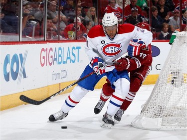 Devante Smith-Pelly #21 of the Montreal Canadiens skates with the puck ahead of John Moore #17 of the Arizona Coyotes during the second period of the NHL game at Gila River Arena on March 7, 2015 in Glendale, Arizona.