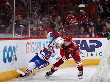 Jeff Petry #26 of the Montreal Canadiens falls into the boards as he skates after the puck against Klas Dahlbeck #34 of the Arizona Coyotes during the second period of the NHL game at Gila River Arena on March 7, 2015 in Glendale, Arizona.