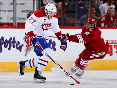 Alex Galchenyuk #27 of the Montreal Canadiens skates with the puck under pressure from Martin Erat #10 of the Arizona Coyotes during the first period of the NHL game at Gila River Arena on March 7, 2015 in Glendale, Arizona.