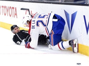 Brayden McNabb (3) of the Los Angeles Kings is knocked to the ice by Jacob De La Rose (25) of the Montreal Canadiens during the first period at Staples Center on March 5, 2015 in Los Angeles, California.