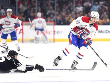 Lars Eller (81) of the Montreal Canadiens avoids a check from Brayden McNabb (3) of the Los Angeles Kings during the first period at Staples Center on March 5, 2015 in Los Angeles, California.