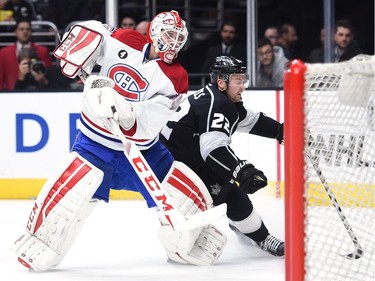 Dustin Tokarski (35) of the Montreal Canadiens clears the puck from Trevor Lewis (22) of the Los Angeles Kings during the second period at Staples Center on March 5, 2015 in Los Angeles, California.
