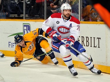 Back in March 24, 2015, Gabriel Bourque of the Nashville Predators watches Andrei Markov of the Montreal Canadiens skate with the puck during the first period at Bridgestone Arena, in Nashville, Tenn.
