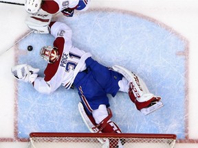 Carey Price #31 of the Montreal Canadiens makes a third period save against the New York Islanders at the Nassau Veterans Memorial Coliseum on March 14, 2015 in Uniondale, New York. The Canadiens defeated the Isalnders 3-1.