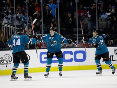 Ben Smith (#21) of the San Jose Sharks celebrates his goal with teammates Tomas Hertl (#48) and Marc-Edouard Vlasic (#44) against the Montreal Canadiens in the first period at SAP Center on March 2, 2015 in San Jose, California.