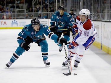 Justin Braun (#61) of the San Jose Sharks deflects a pass by David Desharnais (#51) of the Montreal Canadiens at SAP Center on March 2, 2015 in San Jose, California.