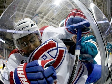 Devante Smith-Pelly (#21) of the Montreal Canadiens is checked into the glass by Brenden Dillon (#4) of the San Jose Sharks at SAP Center on March 2, 2015 in San Jose, California.