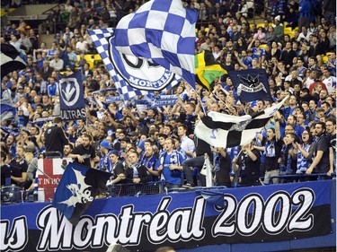 Montreal Impact fans celebrate during their team's 2-0 win over LD Alajuelense during the first leg of the CONCACAF semi-final soccer action Wednesday, March 18, 2015, in Montreal.