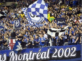 Montreal Impact fans celebrate during 2-0 win over Alajuelense during the first leg of CONCACAF Champions League semifinal action at Montreal's Olympic Stadium on March 18, 2015.