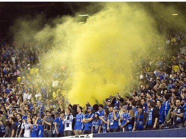Montreal Impact fans let off smoke bombs during their team's 2-0 win over LD Alajuelense during the first leg of the CONCACAF semi-final soccer action Wednesday, March 18, 2015, in Montreal.