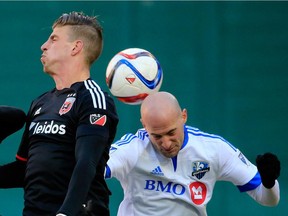 Michael Farfan of D.C. United, left, goes up for the ball with Laurent Ciman of the Montreal Impact during the second half of D.C. United's 1-0 win at RFK Stadium on March 7, 2015, in Washington, D.C.