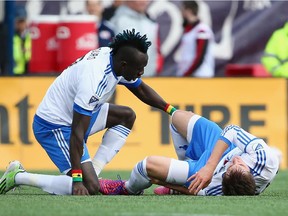 The Impact's Dominic Oduro comforts Cameron Porter after he was injured during the first half against the New England Revolution at Gillette Stadium on March 21, 2015 in Foxboro, Mass.