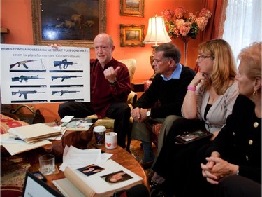 Showing a poster of guns that would not be controlled Jean Francois Laroivee, whose wife was killed at Polytechnique, Jim Edwards, whose daughter Anne Marie was killed at Polytechnique, Louise De Sousa, whose daughter Anastasia was killed at Dawson College, and Suzanne Laplante, mother of Anne-Marie,  were on hand at the Edwars' residence in Pierrefonds in Montreal's west island on Thursday, April 28, 2011, to talk to journalists about the long gun registry , gun control, and their plea to not vote Conservative in the May 2 election.