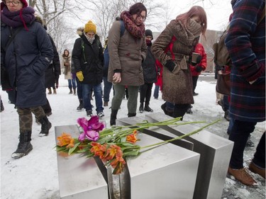 A group participating in a Polytechnique massacre commemoration ceremony walks past a memorial sculpture at Place du 6-Décembre-1989 in Montreal, Saturday December 6, 2014.  It was part of a day of commemorations to mark the 25th anniversary of the murder of 14 women at the École Polytechnique, by Marc Lépine.