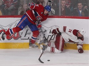 The Canadiens' Alexei Emelin and the Arizona Coyotes' Kyle Chipchura battle for control of the puck during game at the Bell Centre on Feb. 1, 2015.  The Coyotes won 3-2.