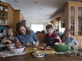 Aimée Wimbush-Bourque with her kids, Clara, Noah and Mateo, making applesauce at home in Laval on Feb. 18, 2015.