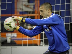 Impact goalkeeper Evan Bush makes a save during drills at Montreal's Olympic Stadium on Feb. 27, 2015.