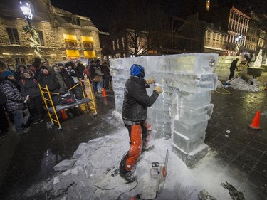 Guy Beauregard works on an ice sculpture in Old Montreal during Nuit Blanche on Saturday, Feb. 28, 2015.