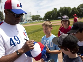 Kids line up to get an autograph from former Expos player Warren Cromartie at Ballantyne Park in Dorval on Saturday, June 16, 2012. The players signed autographs for their fans and held a baseball clinic for people looking to improve their baseball skills.