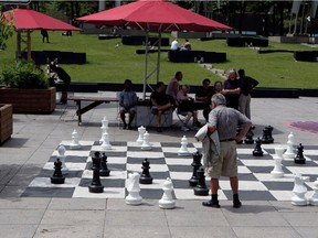 People play chess on an open oversized chess board at Place Émilie-Gamelin in Montreal on Tuesday June 17, 2014.