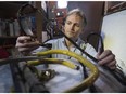 MONTREAL, QUE.: MARCH 02, 2015 --Greg McWhirter holds burned electrical wire from refrigerator on Monday March 02, 2015. The refrigerator started burning while repair crews were trying to thaw out frozen pipes with and electrical current sent through the frozen pipes. (Pierre Obendrauf / MONTREAL GAZETTE)