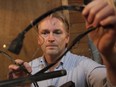 MONTREAL, QUE.: MARCH 02, 2015 --Greg McWhirter holds burned electrical wire from refrigerator on Monday March 02, 2015. The refrigerator started burning while repair crews were trying to thaw out frozen pipes with and electrical current sent through the frozen pipes. (Pierre Obendrauf / MONTREAL GAZETTE)