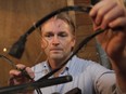 Greg McWhirter holds burned electrical wire from his refrigerator on Monday March 2, 2015. The refrigerator started burning while repair crews were trying to thaw out frozen pipes with an electrical current sent through the frozen pipes.