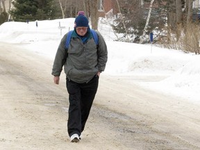 Seventy-two-year-old Gordon Montgomery demonstrates how he dresses for his walks to Hudson from his home in St Lazare, Sunday March 1, 2015.  Montgomery walks every day from his home in St-Lazare to Hudson, and then back again — mostly to the Chateau du Lac bar to meet up with old friends. He regularly gets a ride from motorists who now know him.