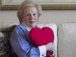Barbara Brock, a longtime hospital volunteer,  with one of the heart-shaped pillows given to patients who undergo heart surgery.