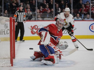 Carey Price keeps his eyes on the puck as Ottawa Senators left wing Milan Michalek looks at the Bell Centre on Thursday, March 12, 2015.