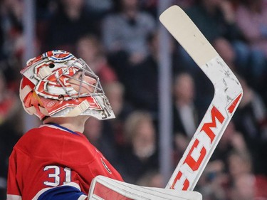 Carey Price looks at the scoreboard after being scored on by Ottawa Senators defenseman Erik Karlsson during the third period at the Bell Centre on Thursday, March 12, 2015.