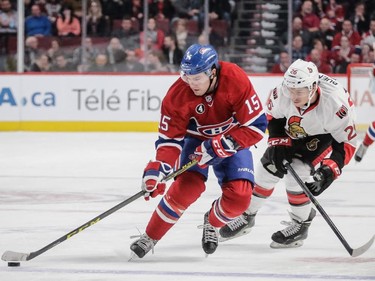 P.A. Parenteau skates past Ottawa Senators left wing Matt Puempel during the second period at the Bell Centre on Thursday, March 12, 2015.