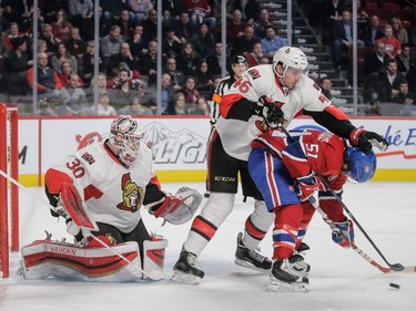 Ottawa Senators defenseman Patrick Wiercioch pushes David Desharnais as they fight for the puck in front of goalie Andrew Hammond during the second period at the Bell Centre on Thursday, March 12, 2015.