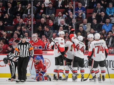 Ottawa Senators players celebrate the goal by Erik Condra, obscured, in front of goalie Carey Price and teammate Tomas Plekanec, kneeling, during the second period at the Bell Centre on Thursday, March 12, 2015.
