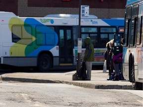 Passengers wait to board STM buses at the Fairview STM terminal in 
pointe-Claire.