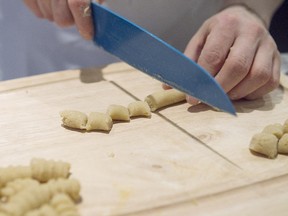 Marlee Felberbaum cuts gnocchi "pillows" from dough she has rolled out after mixing together Yukon Gold potatoes, cake meal, potato starch, egg yolks, Parmesan and nutmeg during an Italian-themed cooking class aimed at rejuvenating Passover menus.