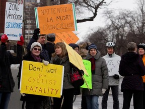 Cyclists and pedestrians hold a demonstration at the corner of Décarie and de Maisonneuve in Montreal on Monday March 16, 2015. The group is trying to get the local borough to add a 20-second phase to the traffic signal at that intersection to make it safer for pedestrians and cyclists.
