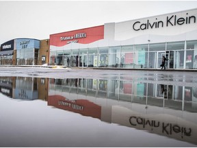 A shopper exits a Calvin Klein retail store at Marché Central in Montreal on Tuesday, March 17, 2015. Only 12.8 per cent of Quebec businesses currently sell online