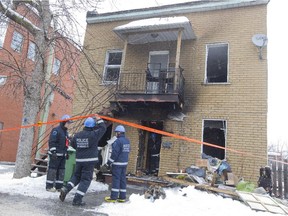 Montreal police arson investigators examine a duplex on Desmarteau St. near Hochelaga St. in Tétreaultville, Montreal, Tuesday March 17, 2015.  Five people were injured or suffered smoke inhalation and one man was burned severely.