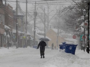 A pedestrian walks along Lakeshore Rd.  on Tuesday March 19, 2013.