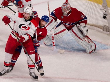 Montreal Canadiens defenseman Andrei Markov tries to clear Carolina Hurricanes centre Jordan Staal from the front of the net as goalie Carey Price follows the play at the Bell Centre on Thursday March 19, 2015.
