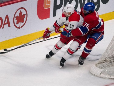 Montreal Canadiens defenseman P.K. Subban and Carolina Hurricanes right wing Patrick Dwyer get tied up as they round the net at the Bell Centre on Thursday, March 19, 2015.