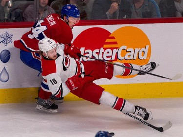 Montreal Canadiens defenseman Alexei Emelin sends Carolina Hurricanes centre Elias Lindholm to the ice at the Bell Centre on Thursday, March 19, 2015.