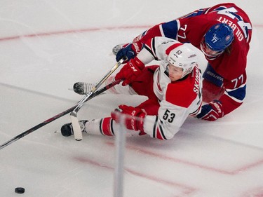 Montreal Canadiens defenseman Tom Gilbert and Carolina Hurricanes left wing Jeff Skinner fall to the ice at the Bell Centre on Thursday, March 19, 2015.
