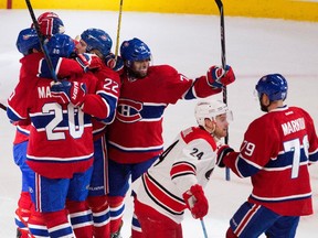 The Montreal Canadiens celebrate right wing Dale Weise's opening goal as Carolina Hurricanes centre Brad Malone returns to the bench at the Bell Centre on Thursday, March 19, 2015.