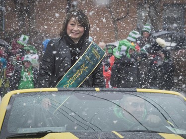 The Grand Marshal  and CTV newscaster Mutsumi Takahashi keeps the smile going during a heavy snowfall during the 6th annual St. Patrick's Day parade in Hudson on Saturday, March 21, 2015.